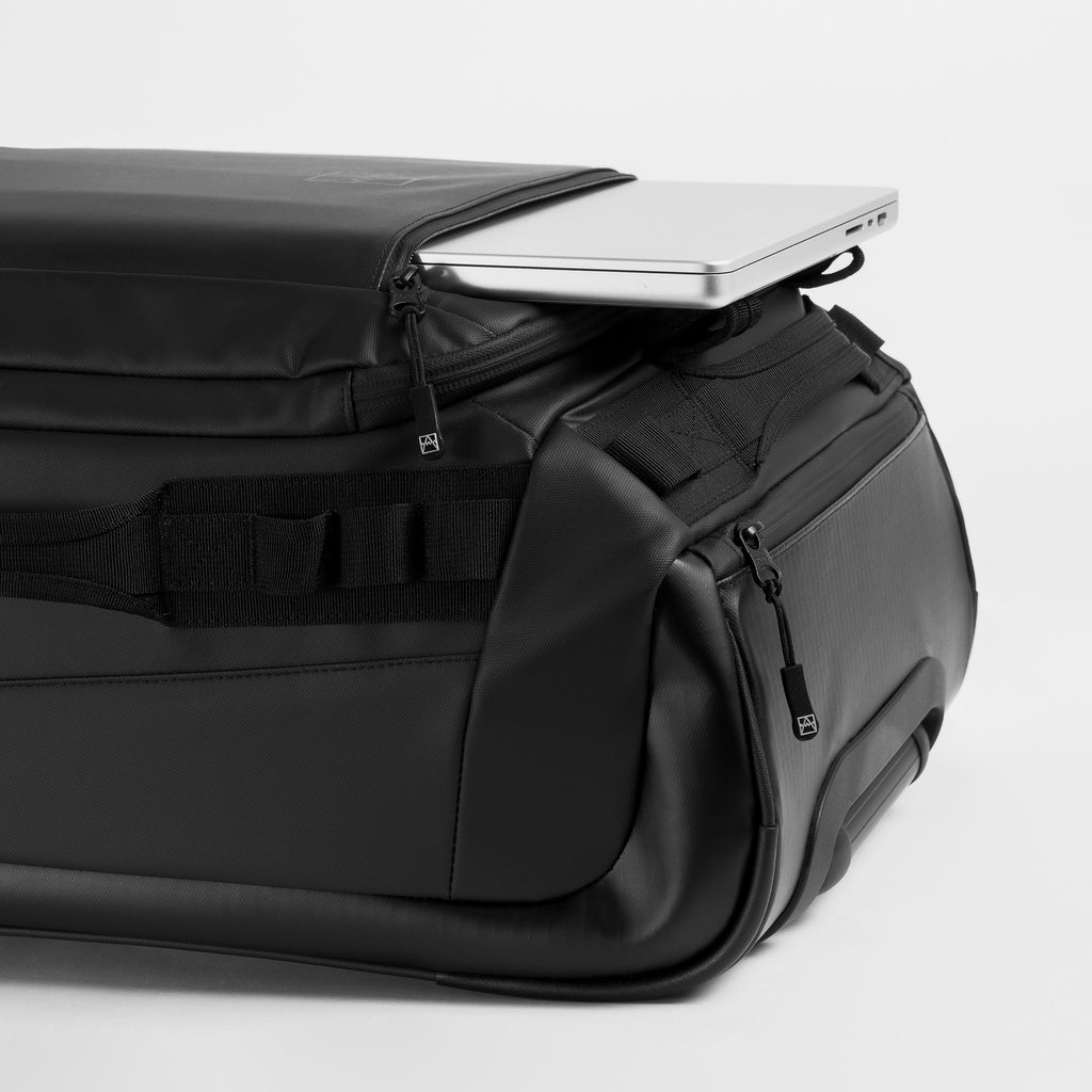 A studio shot of the laptop compartment on the Wheeled Kit Bag 40L in All Black