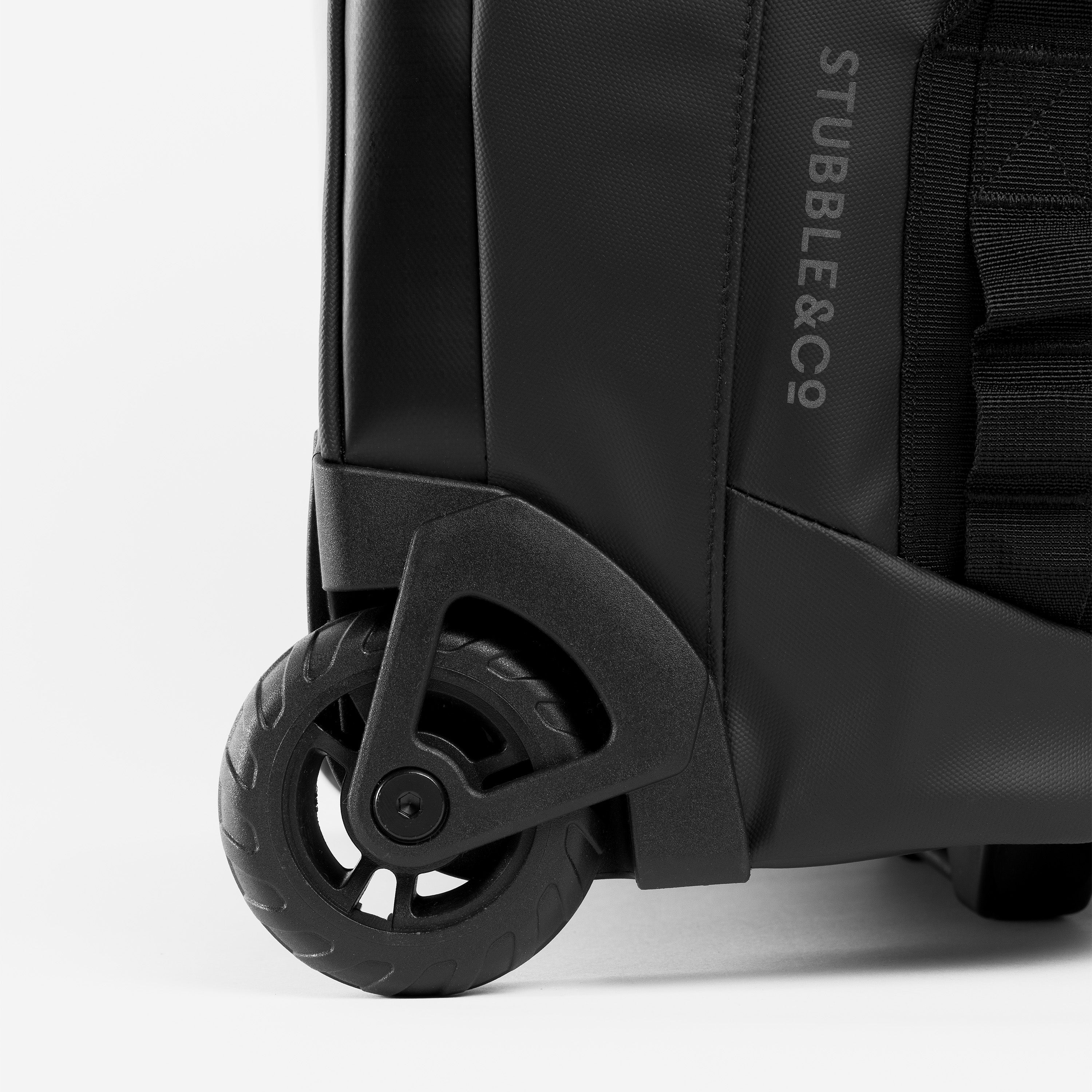 A studio shot of the multi-terrain wheels on the Wheeled Kit Bag 40L in All Black